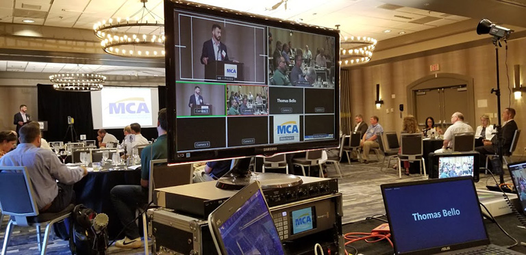 MCAMW Executive Vice President Tom Bello speaking live and captured on MTI's screen and livestreaming equipment.