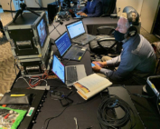 MTI's John Bogley monitors three laptops to keep the program both live and streaming.