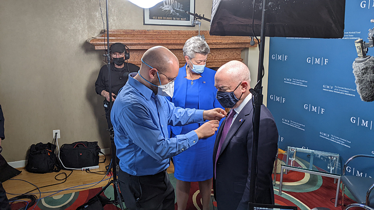 Audio expert Josh Roberts makes sure that Secretary of Homeland Security Mayorkas and EU Commissioner for Home Affairs Johansson are properly mic'd.