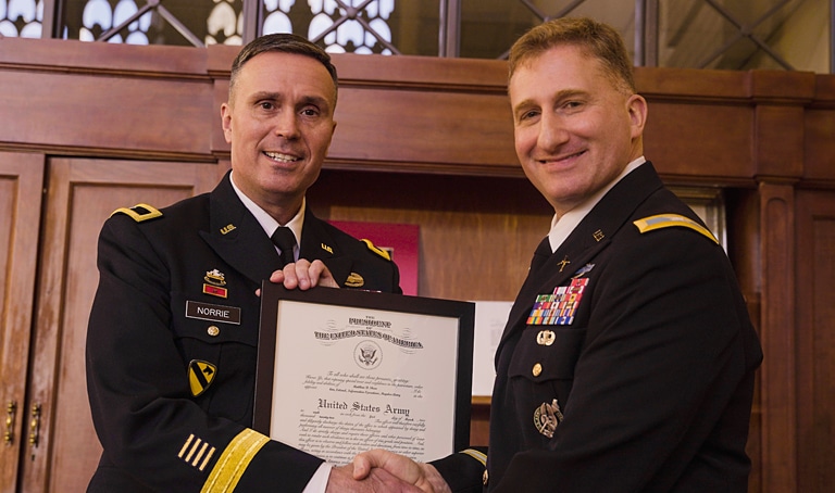 Brigadier General Christopher Norrie (l) congratulates our client, Colonel Matthew Shaw, on his promotion to the rank of United States Army Colonel.