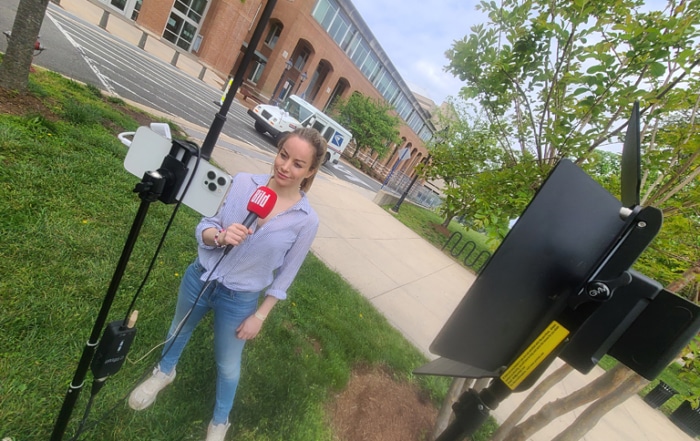 Katie Pfleghar, a reporter for German news site BILD, uses Skype to file reports, aided by MTI's crew and equipment.