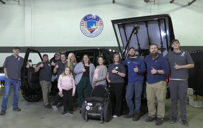 Family, friends, and employees of Driver Rehabilitation Center Of Excellence in Chantilly, Va., celebrate JD Williams' new vehicle.