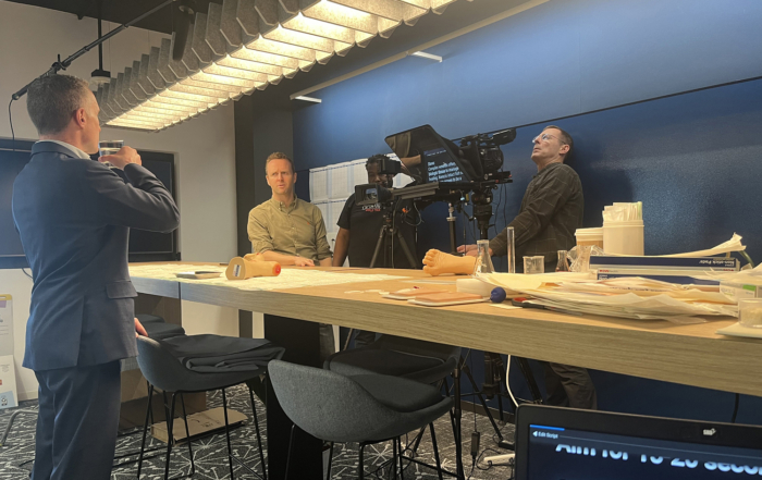 Video production for Kerecis, Steve Dunn, of the medical technology firm studies the script with Teleprompter operator Justin Klein as Albert Liesegang and Wesley Bailey line up the shot.