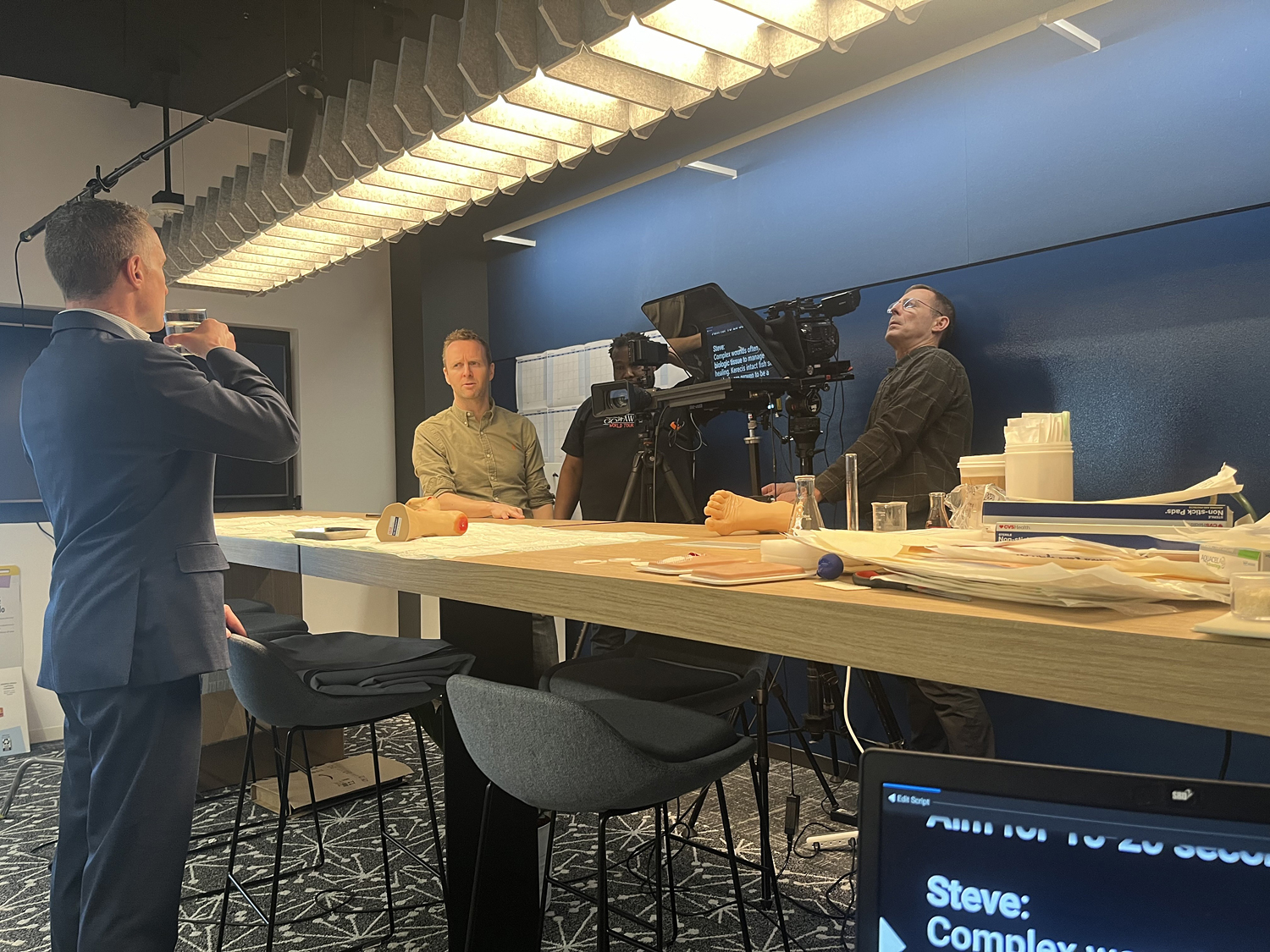 Video production for Kerecis, Steve Dunn, of the medical technology firm studies the script with Teleprompter operator Justin Klein as Albert Liesegang and Wesley Bailey line up the shot.