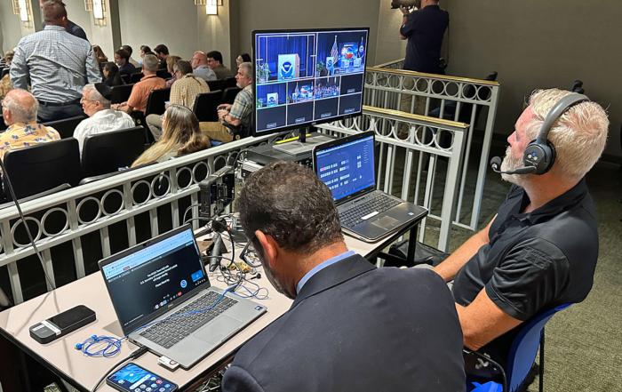 Director John Bogley monitors the three cameras needed to cover the event.