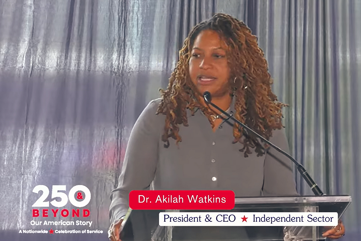 Dr. Akilah Watkins, president and CEO of Independent Sector, speaks at the 250 & Beyond event.