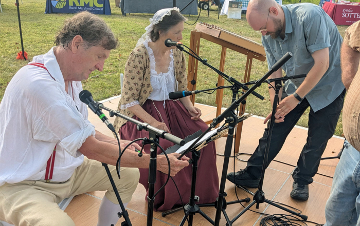 Josh Roberts makes sure that the musicians are properly wired and ready to perform.